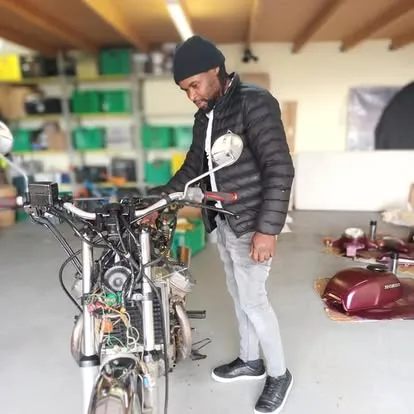 Erik rebuilding a motorbike in the workshop